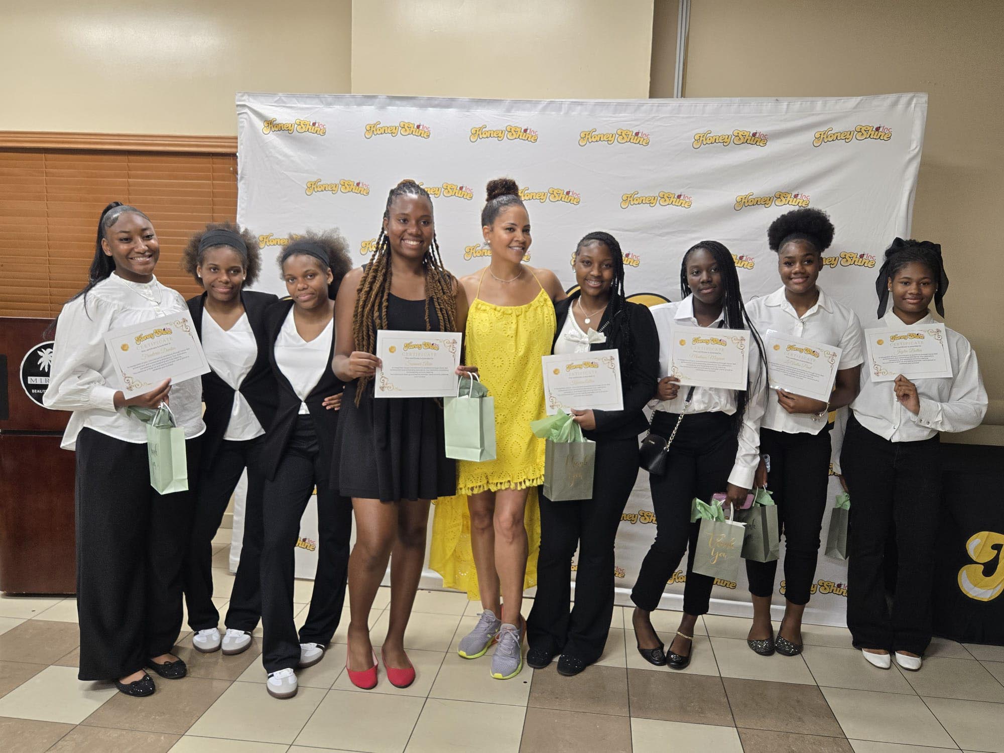 a group og girls proudly display their recently earned certificates