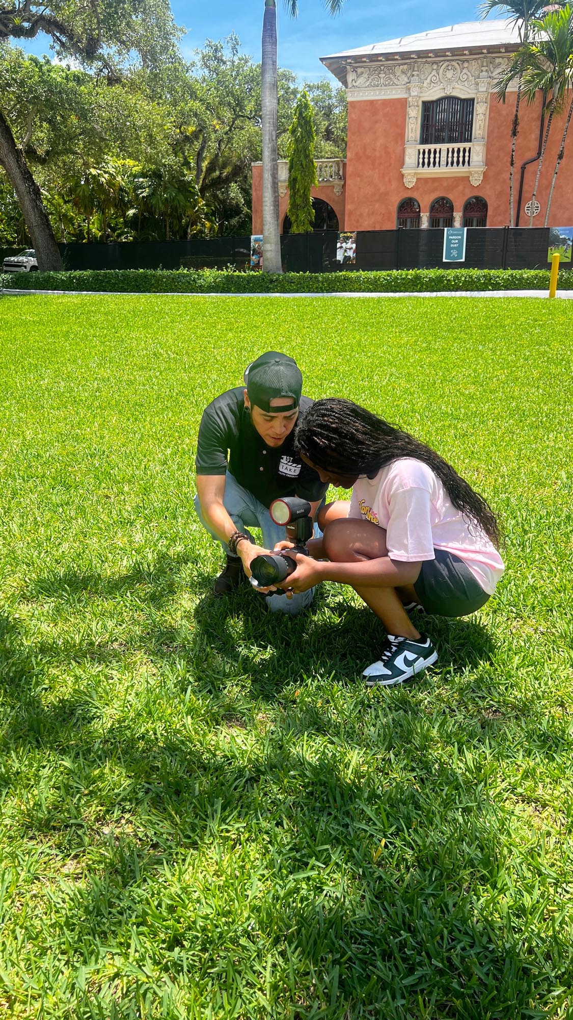 a student is shown how to use a camera by a counselor