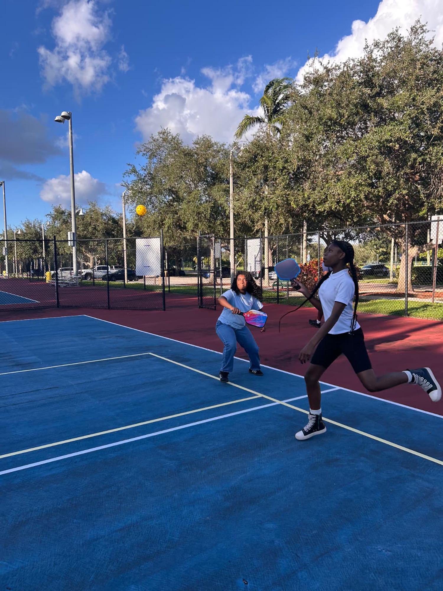 two youths play pickleball